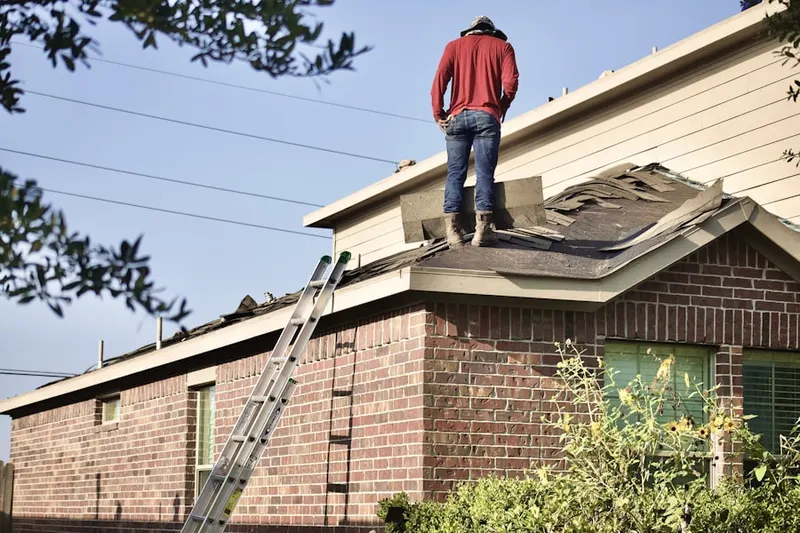 Professional roofer working on a residential roof in Fox River Heights